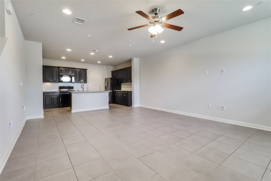 6814 East Riverside Drive, Unit 32 Austin, TX 78741 - Photo 24 of 27 a view of a kitchen with a sink and a refrigerator