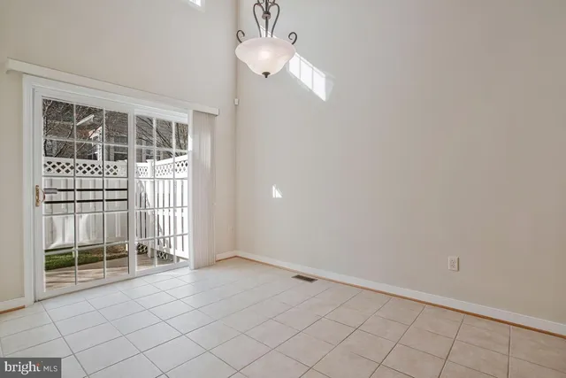 a view of a livingroom with wooden floor and window