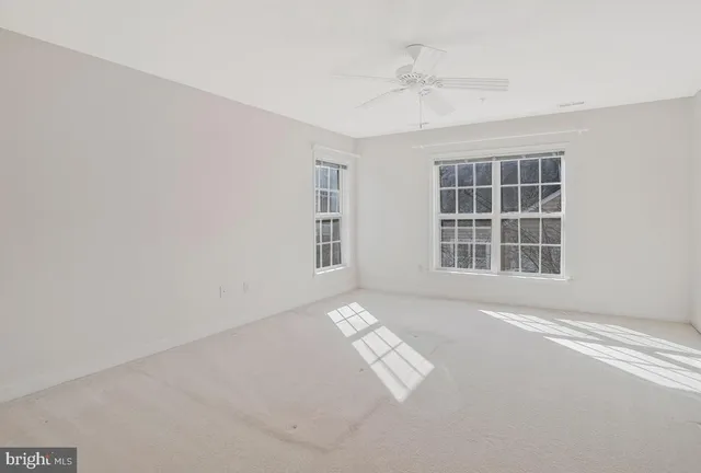 a living room with furniture and large windows