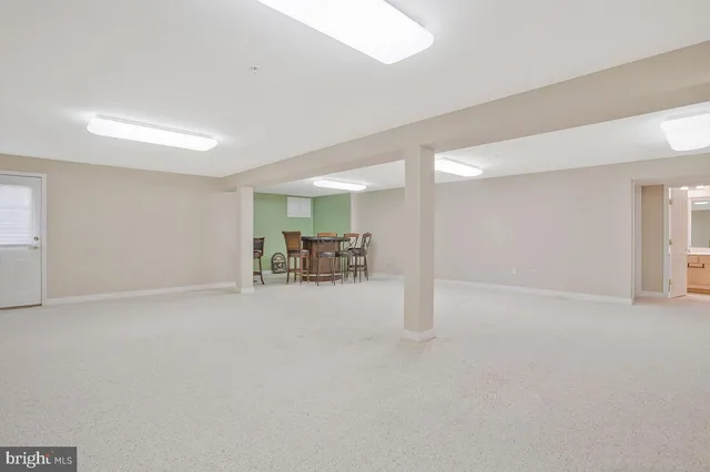 a view of a dining room with furniture a chandelier and a rug
