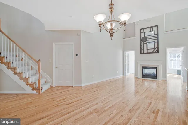a view of a livingroom with a fireplace wooden floor and window
