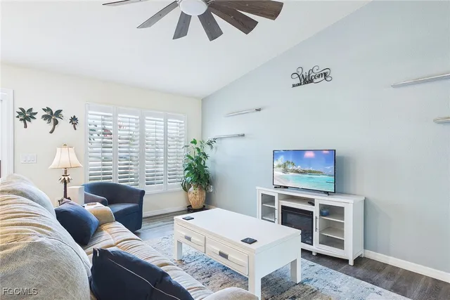 a living room with furniture a chandelier and a window