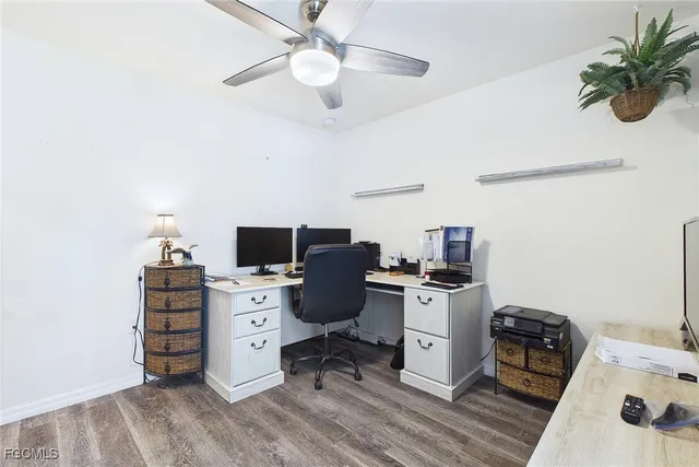 a view of a workspace with furniture and a window