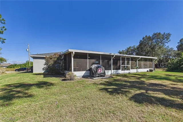 a view of a house with a yard and sitting area