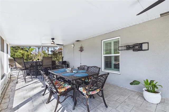 a view of a dining room with furniture and a potted plant