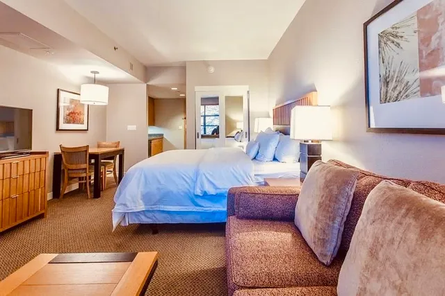 a living room with furniture and a lamp