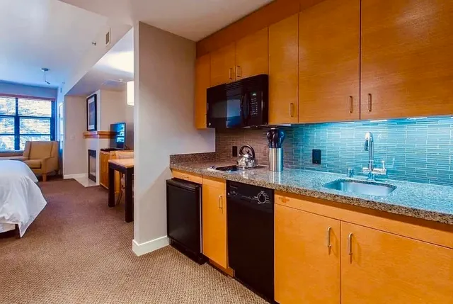 an aerial view of a house with swimming pool and outdoor seating