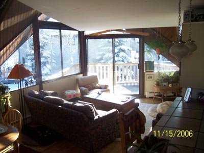 1400 Lions Ridge Loop, Unit 5 Vail, CO 81657 - Photo 3 of 5 a living room with furniture and a floor to ceiling window