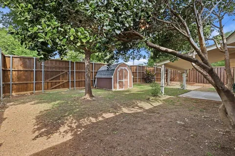 a front view of a house with a yard and a garage