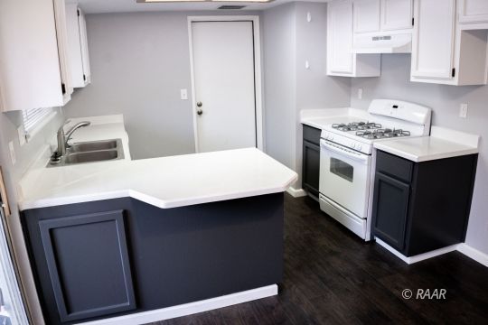 148 South Lilac Street Ridgecrest, CA 93555 - Photo 12 of 34 a kitchen with a sink cabinets and wooden floor