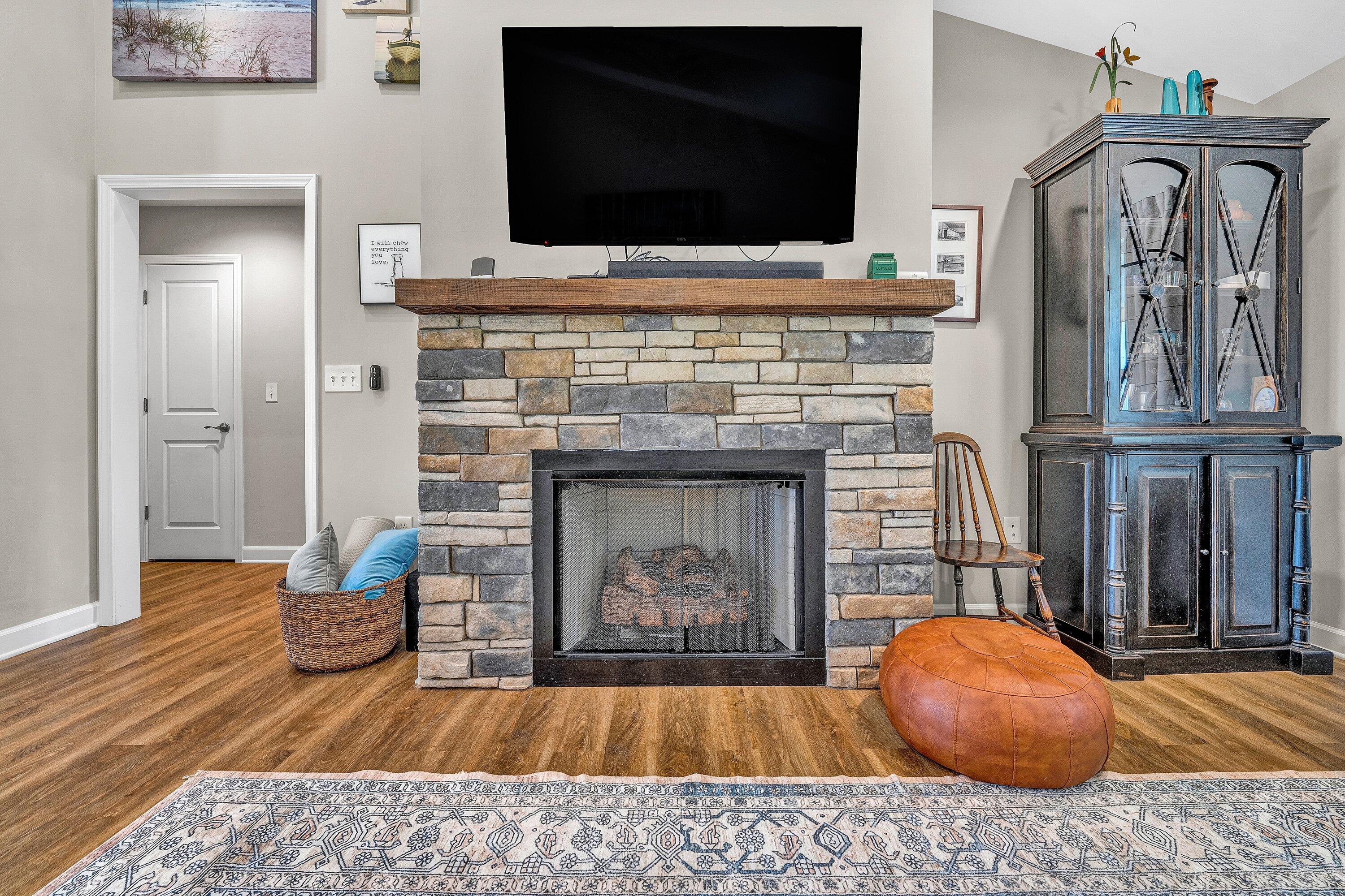915 Morewood Road Hardy, VA 24101 - Photo 4 of 58 a living room with a fireplace and a flat screen tv