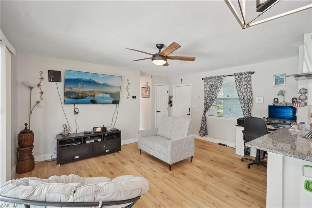 501 Penn Road West Lehigh Acres, FL 33936 - Photo 17 of 27 a living room with furniture and a flat screen tv