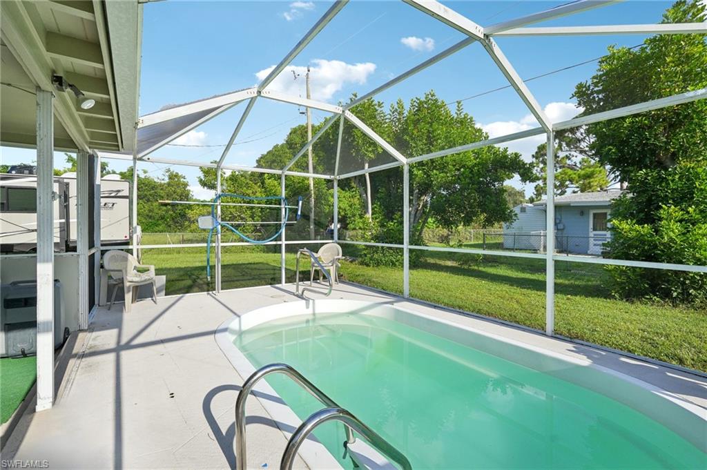 501 Penn Road West Lehigh Acres, FL 33936 - Photo 7 of 27 a view of a chair and table in the backyard
