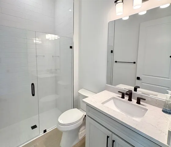a bathroom with a sink toilet and shower