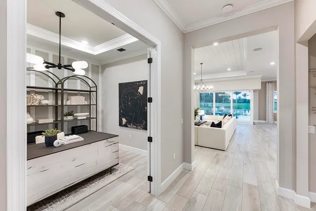 a very nice looking room with a large window and chandelier