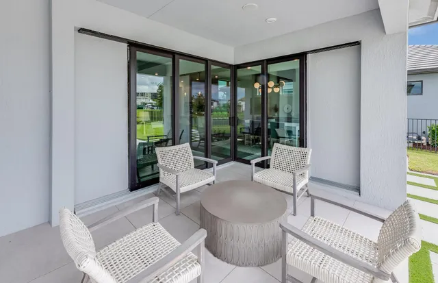 a living room with furniture and large windows
