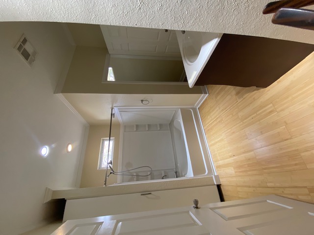 1034 Magnolia Street Lockhart, TX 78644 - Photo 3 of 12 Full bath featuring vanity, light wood-type flooring, bathing tub / shower combination, crown molding, and recessed lighting