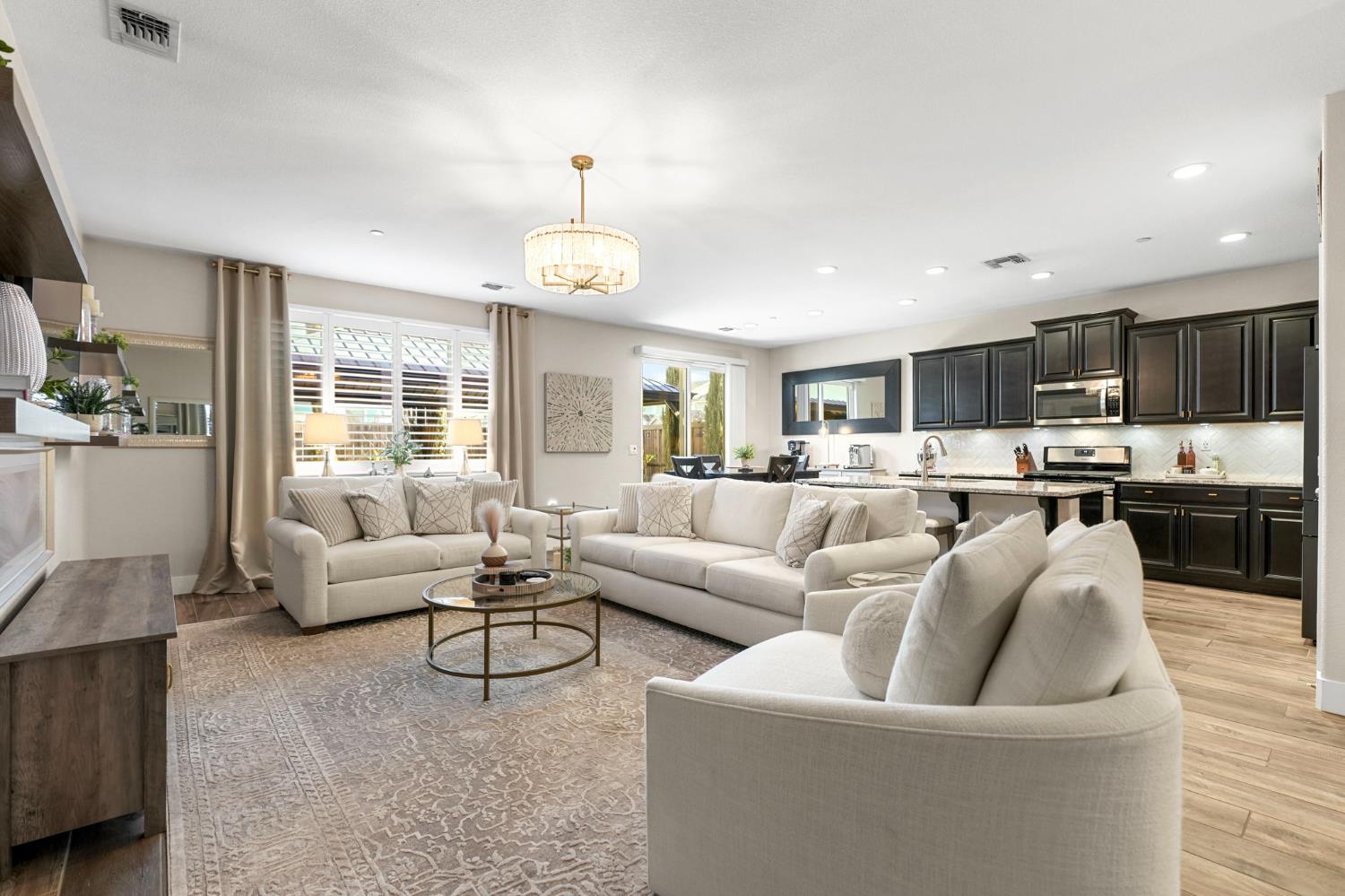 1642 Mcmanis Lane Ripon, CA 95366 - Photo 14 of 44 a living room with furniture kitchen and a wooden floor