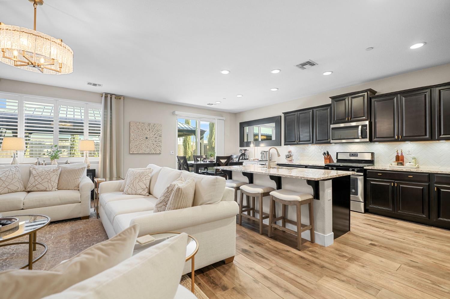 1642 Mcmanis Lane Ripon, CA 95366 - Photo 17 of 44 a living room with stainless steel appliances furniture and a large window