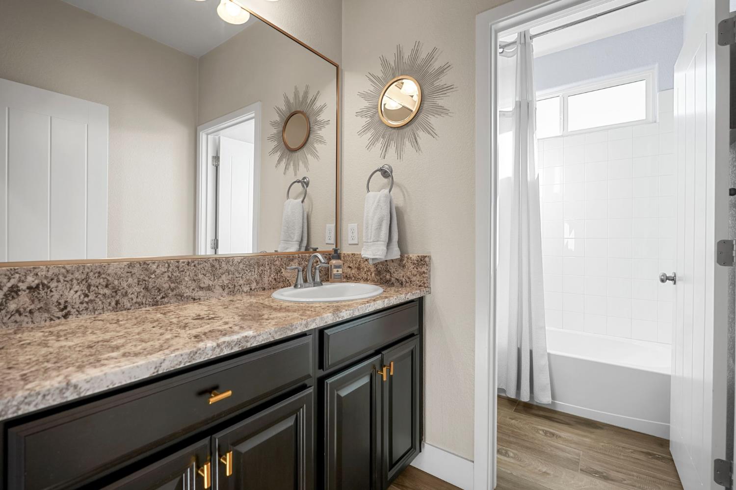 1642 Mcmanis Lane Ripon, CA 95366 - Photo 9 of 44 a bathroom with a granite countertop sink and a mirror