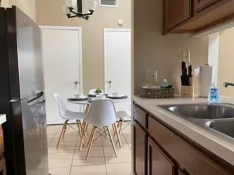 a kitchen with a table chairs sink and cabinets