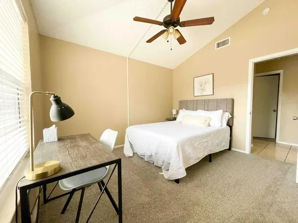 a bedroom with a bed and a chandelier