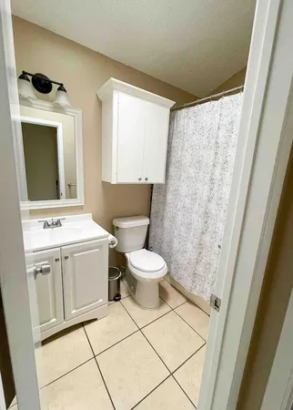 a bathroom with a sink toilet and mirror