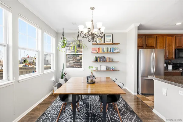 a view of a dining room with furniture window and wooden floor