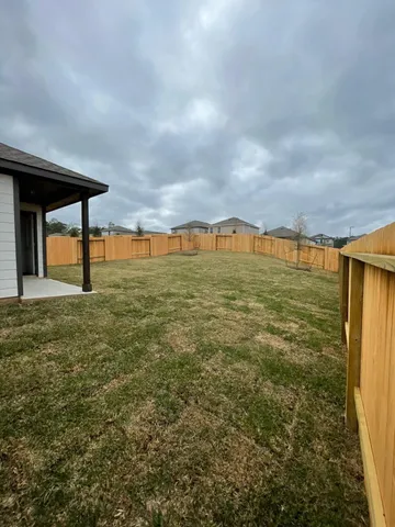 a view of a house with a yard and sitting area