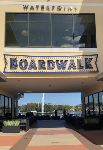 a view of a lake with a big yard and large trees