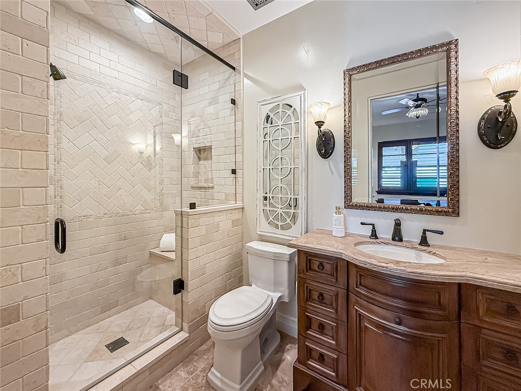 3826 Bowsprit Circle Westlake Village, CA 91361 - Photo 31 of 72 a bathroom with a double vanity sink toilet mirror and shower