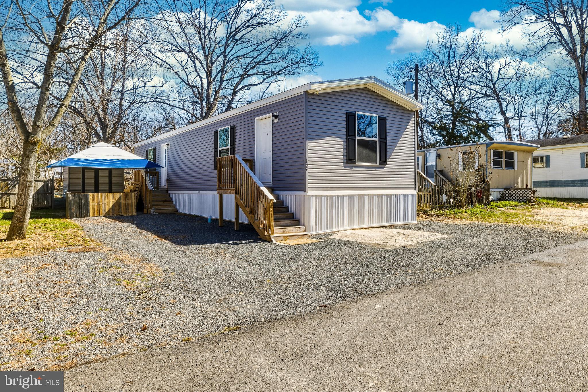260 Marshall Mill Road, Unit 132 Malaga, NJ 08328 - Photo 1 of 11 a view of a house with a yard covered in snow