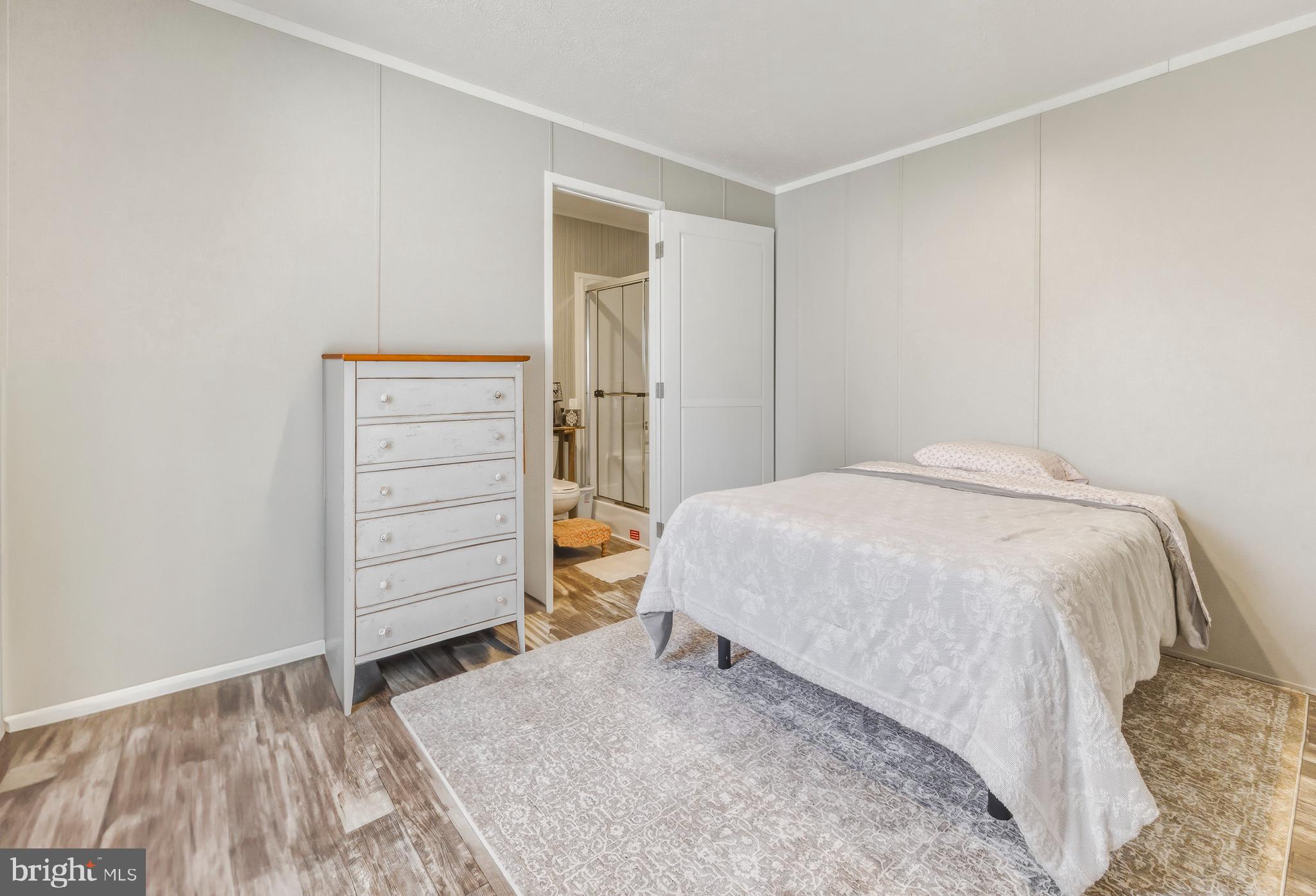 260 Marshall Mill Road, Unit 132 Malaga, NJ 08328 - Photo 3 of 11 a bedroom with a bed and a window