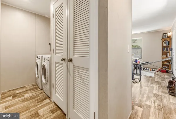 a view of a hallway with a dining table & chairs