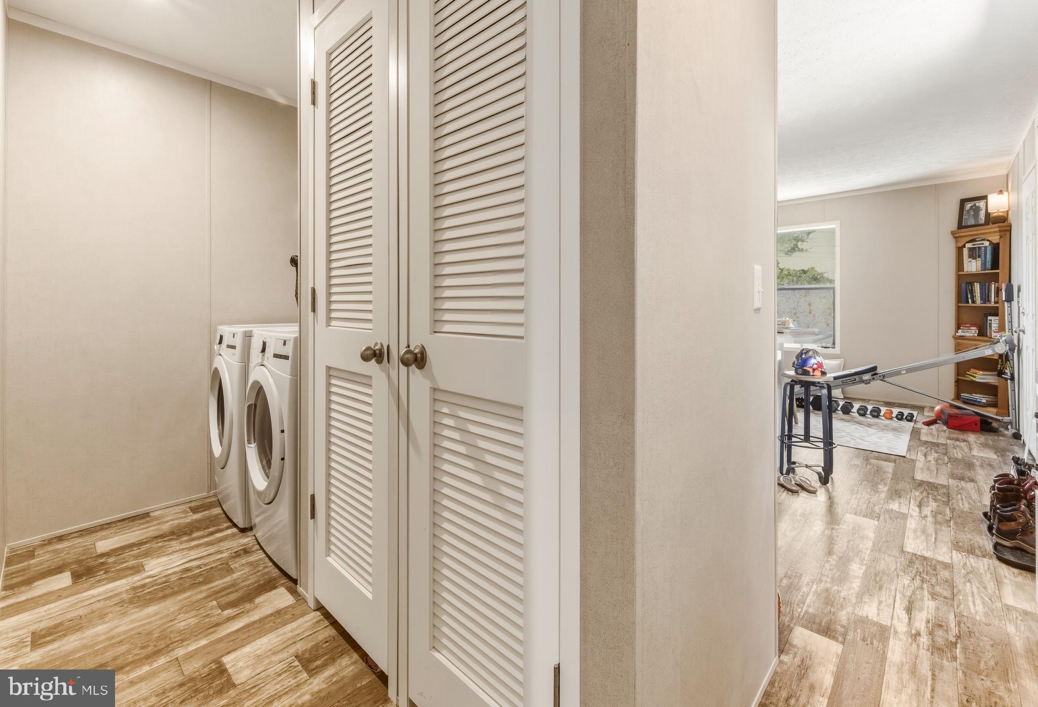 260 Marshall Mill Road, Unit 132 Malaga, NJ 08328 - Photo 6 of 11 a view of a hallway with a dining table & chairs