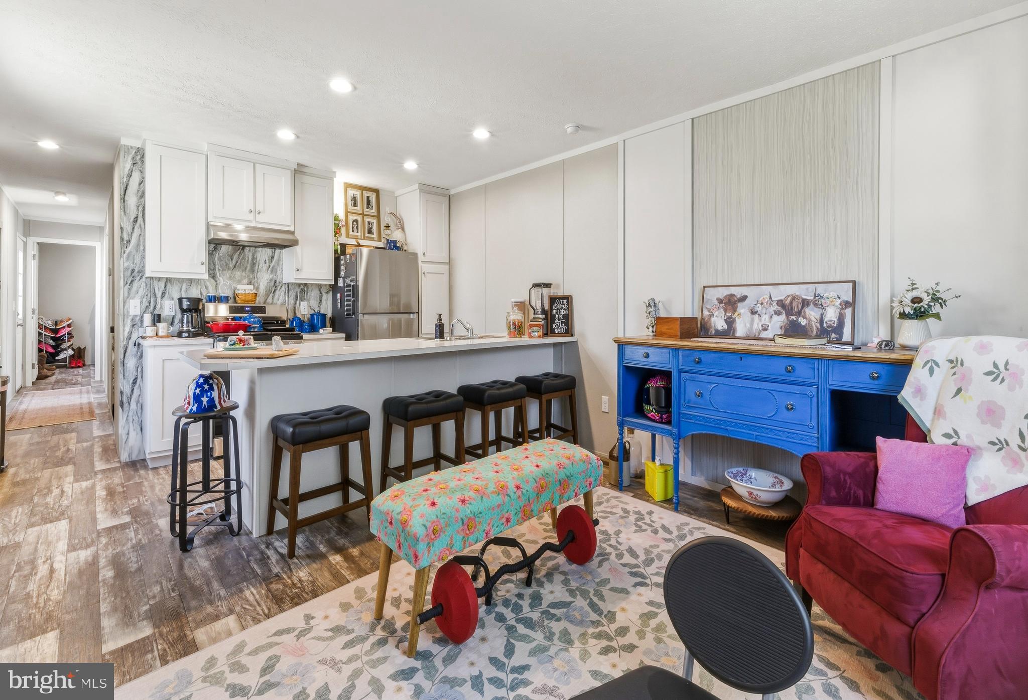 260 Marshall Mill Road, Unit 132 Malaga, NJ 08328 - Photo 8 of 11 a living room with furniture and a dining table with kitchen view