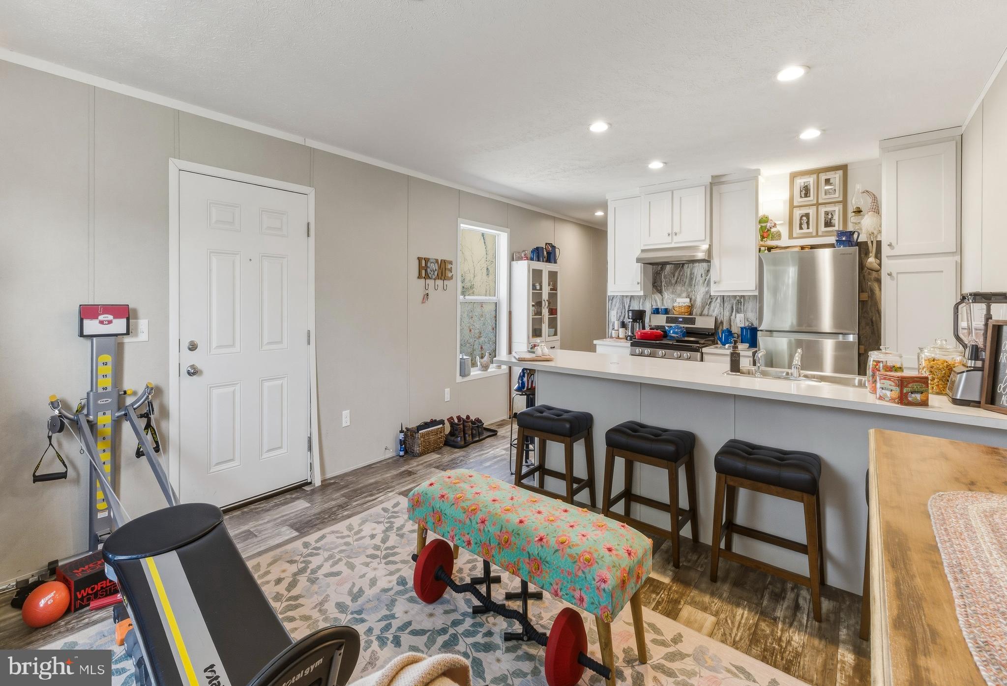 260 Marshall Mill Road, Unit 132 Malaga, NJ 08328 - Photo 9 of 11 a living room with furniture and a wooden floor