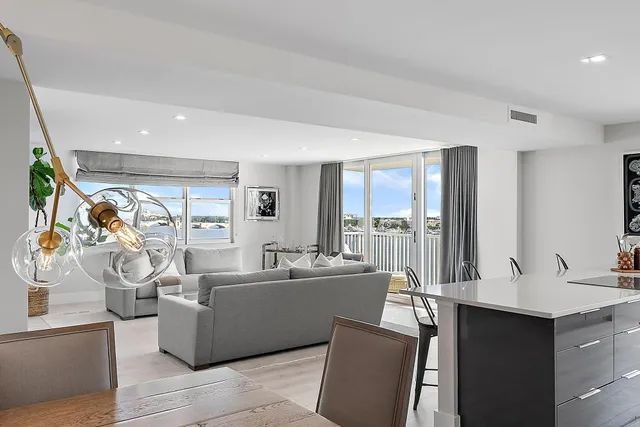 a view of a dining room with furniture a livingroom and chandelier