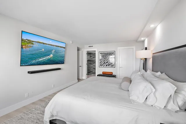 a bedroom with a bed and a painting on the wall