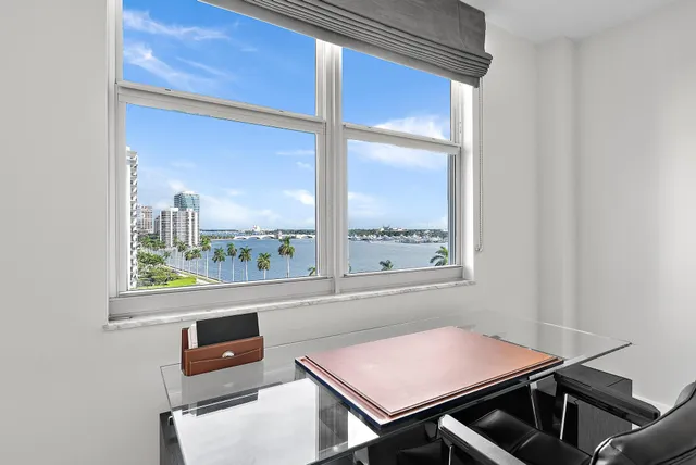 a bathroom with a granite countertop sink a mirror and shower