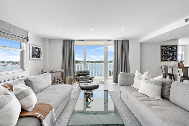 a living room with furniture and large windows