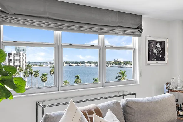 a living room filled with furniture and a large window