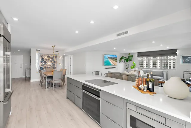 a kitchen with a sink dining table and chairs