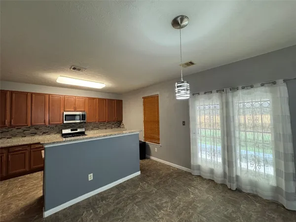 a kitchen with stainless steel appliances granite countertop a sink and refrigerator