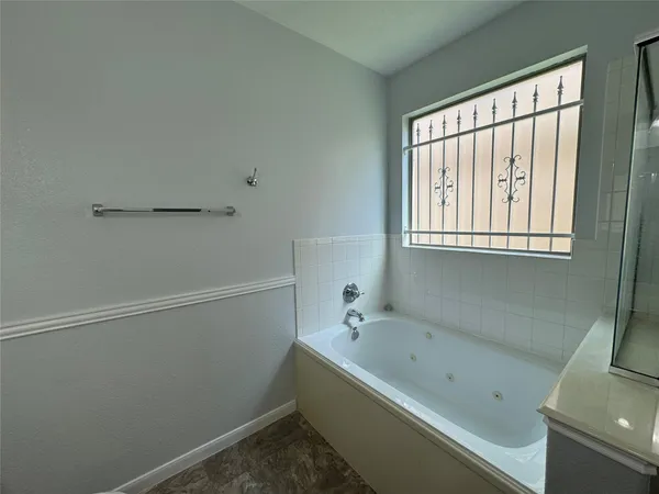a bathroom with a bathtub and window