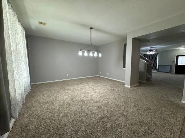 en empty room with windows and outdoor view