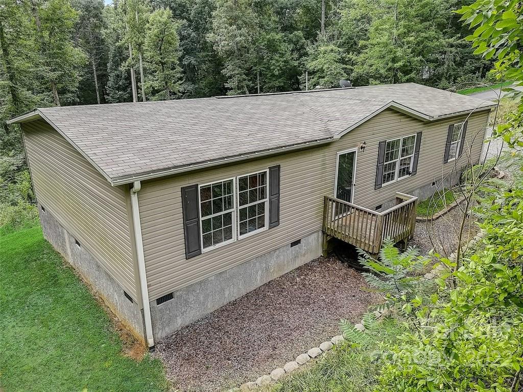 a view of a house with a yard and wooden fence