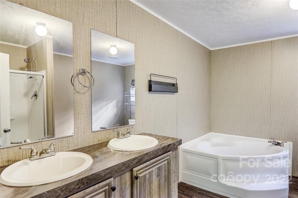 78 Alexander Road Alexander, NC 28701 - Photo 12 of 21 a bathroom with a granite countertop sink a mirror and a toilet