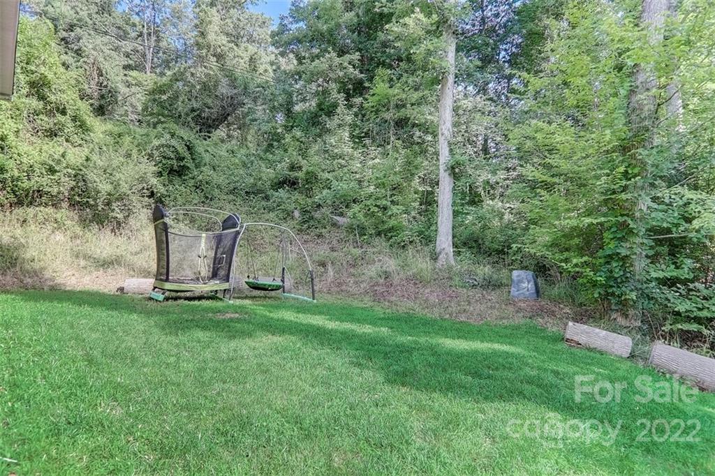 78 Alexander Road Alexander, NC 28701 - Photo 3 of 21 a backyard of a house with lots of green space and fountain