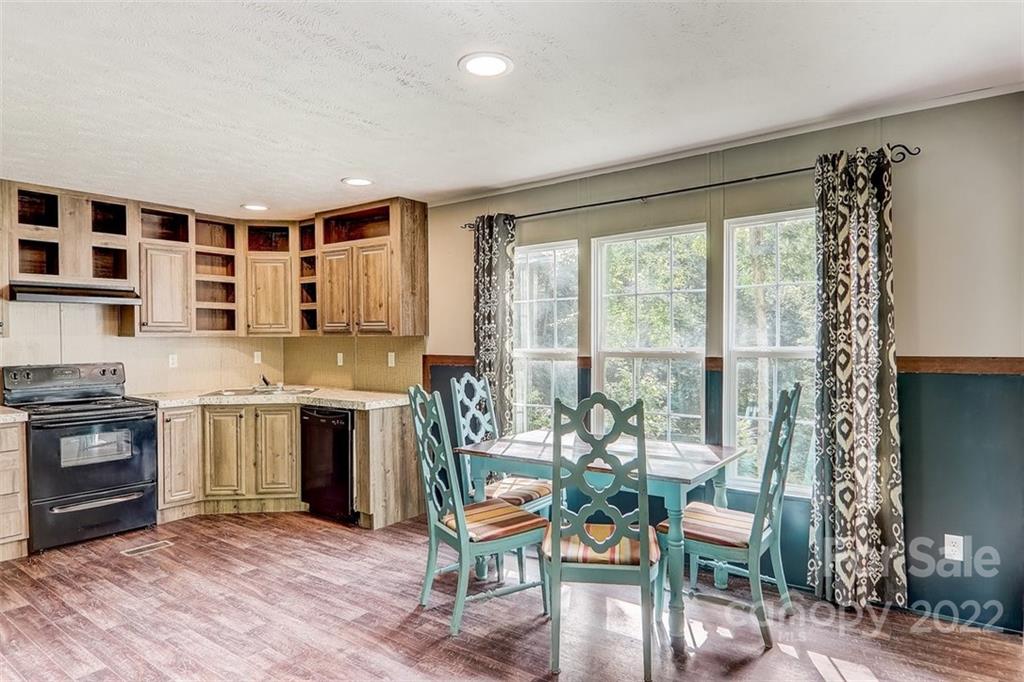 78 Alexander Road Alexander, NC 28701 - Photo 6 of 21 a kitchen with a table chairs stove and cabinets